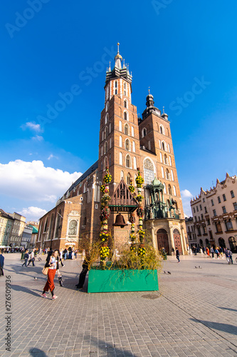 Krakow, Poland - April, 2019: Old city center view with Adam Mickiewicz monument and St. Mary's Basilica in Krakow photo