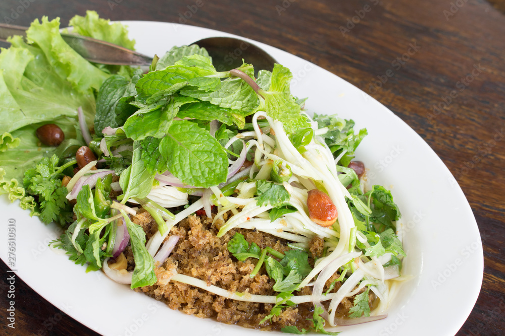 mint leaf on spicy fried catfish salad on white dish mint leaf on spicy fried catfish salad on white dish