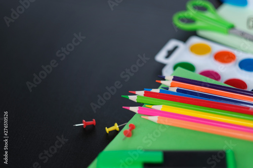 School supplies on black board background. Back to school concept. View from above