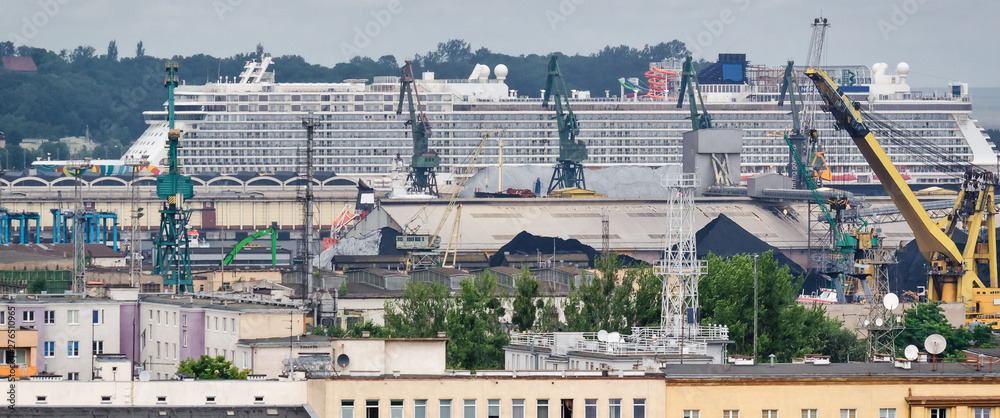 CRUISE SHIP - A colossal passenger ship dominating the size of the seaport in Gdynia