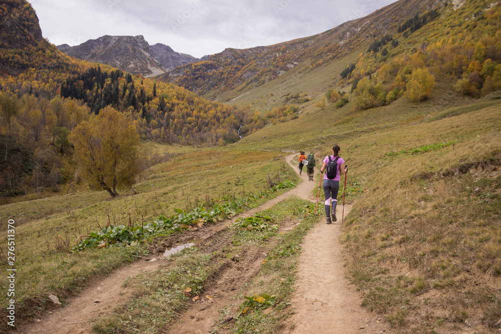 young people travel through the mountains in the autumn