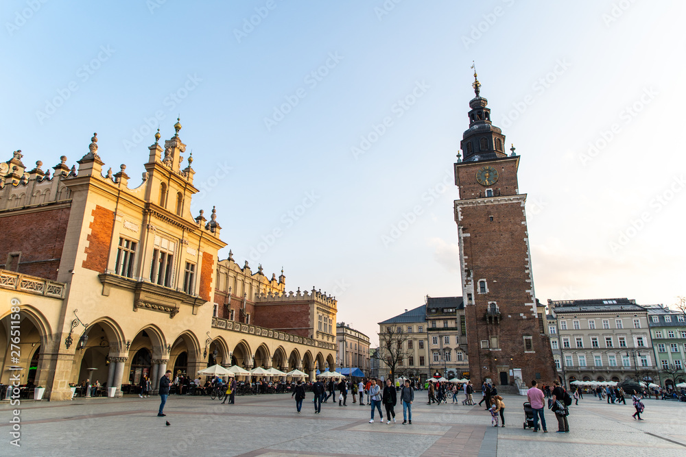 Naklejka premium Krakow, Poland - April, 2019: Church of St. Mary and the Cloth Hall on the main market square in Krakow