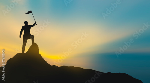 silhouette of man on mountain top over sky and sun light background business  success  leadership  achievement and people concept