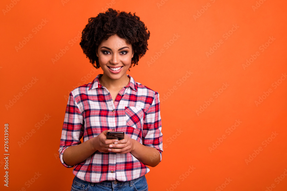 Photo of funny pretty lady hold hands telephone writing letter email wear casual checkered plaid shirt isolated orange bright background Photo of funny pretty lady hold hands telephone writing letter email wear casual checkered plaid shirt isolated orange bright background