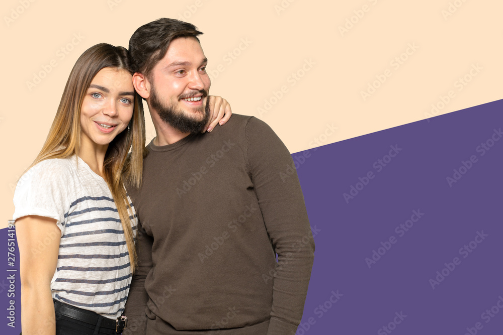 Happy couple embracing and looking at camera Happy couple embracing and looking at camera