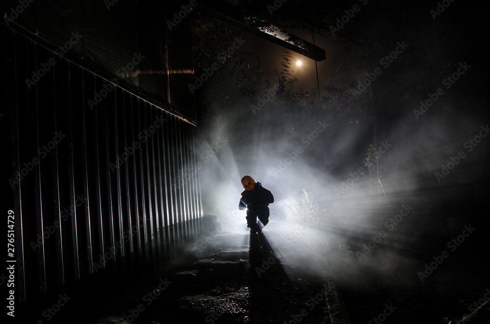 Horror scene of a scary children's ghost, Silhouette of scary baby doll on dark foggy background with light. Horror scene of a scary children's ghost, Silhouette of scary baby doll on dark foggy background with light.