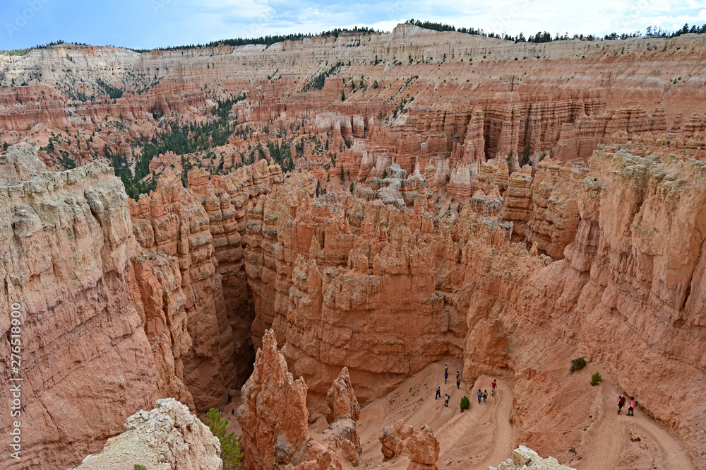 Distant hikers descending the switchbacks of the Navajo Loop Trail in Bryce Canyon National Park, Utah in afternoon light. Distant hikers descending the switchbacks of the Navajo Loop Trail in Bryce Canyon National Park, Utah in afternoon light.