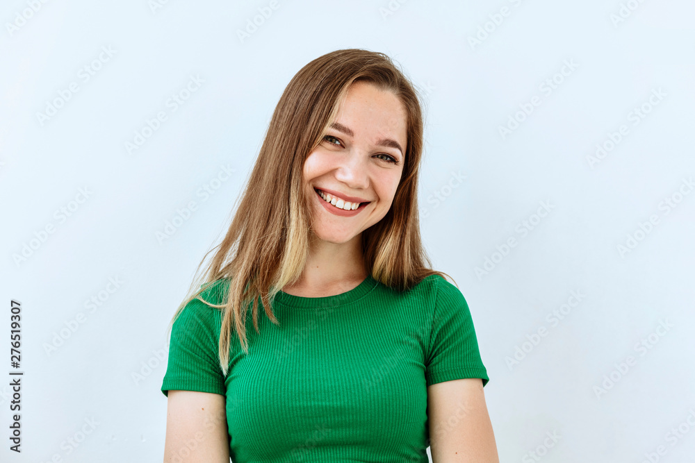 Young girl portrait against white background. Laughter and joy emotions Young girl portrait against white background. Laughter and joy emotions