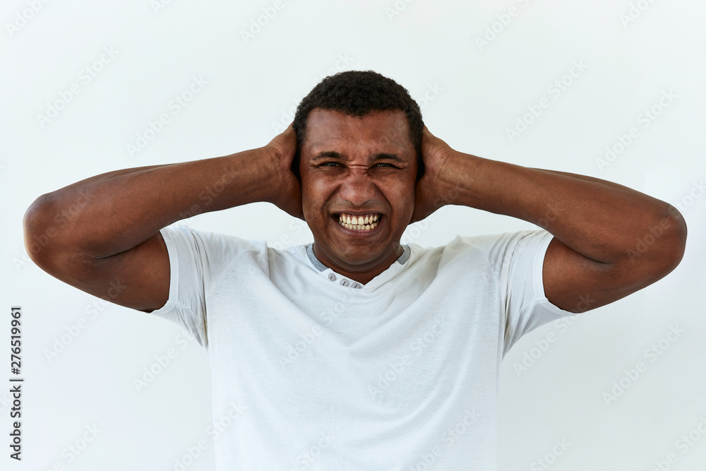 Frustrated and stress emotion. Portrait of African American man against white background Frustrated and stress emotion. Portrait of African American man against white background