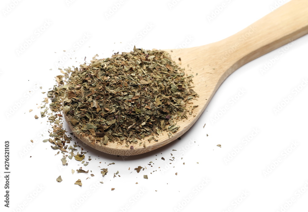 Basil dried spice in wooden spoon isolated on white background Basil dried spice in wooden spoon isolated on white background