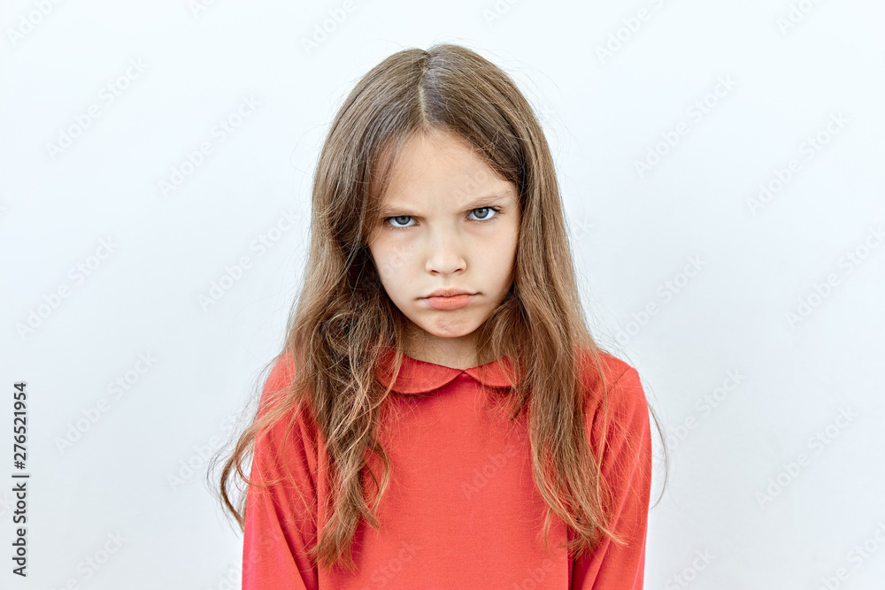 Annoyed and upset emotion. Headshot portrait of Child girl against white background Annoyed and upset emotion. Headshot portrait of Child girl against white background
