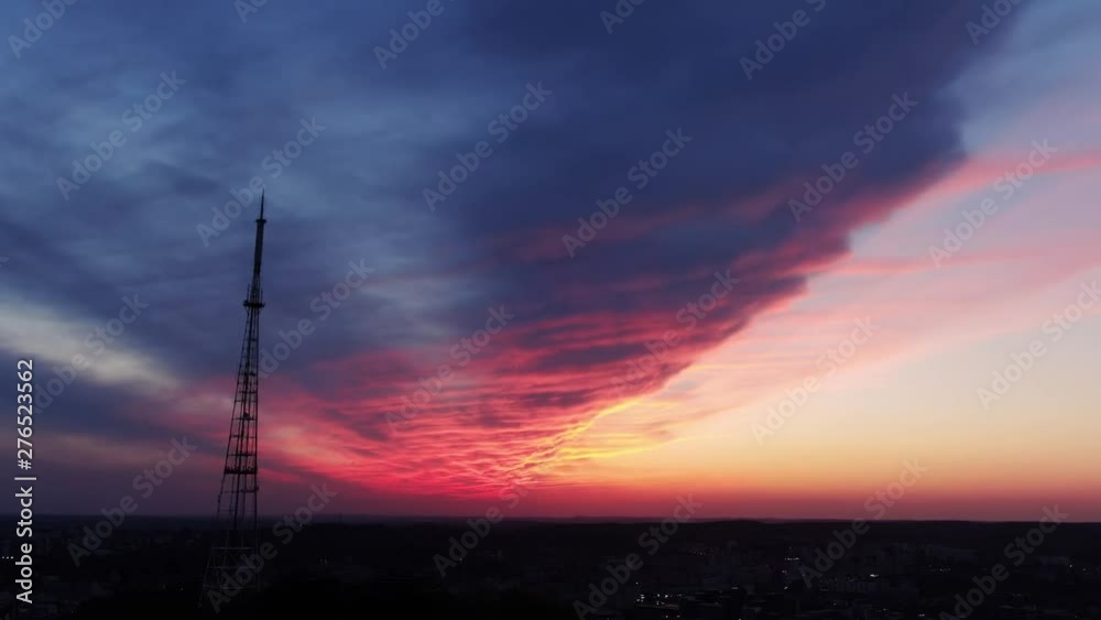 Glorious sunset from the highest viewpoint of the beautiful city. Drone view of dramatic sky clouds and evening cityscape in summer. Glorious sunset from the highest viewpoint of the beautiful city. Drone view of dramatic sky clouds and evening cityscape in summer.