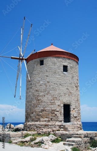 A medieval stone windmill at Mandraki harbour in Rhodes Old Town on the Greek island of Rhodes.