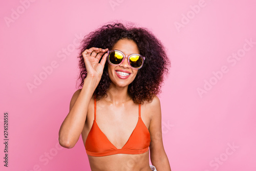 Close up photo funny beautiful she her dark skin lady toothy beaming smile go seaside beach wish suntan exotic island resort wear sun specs swimming orange suit brassiere isolated pink background