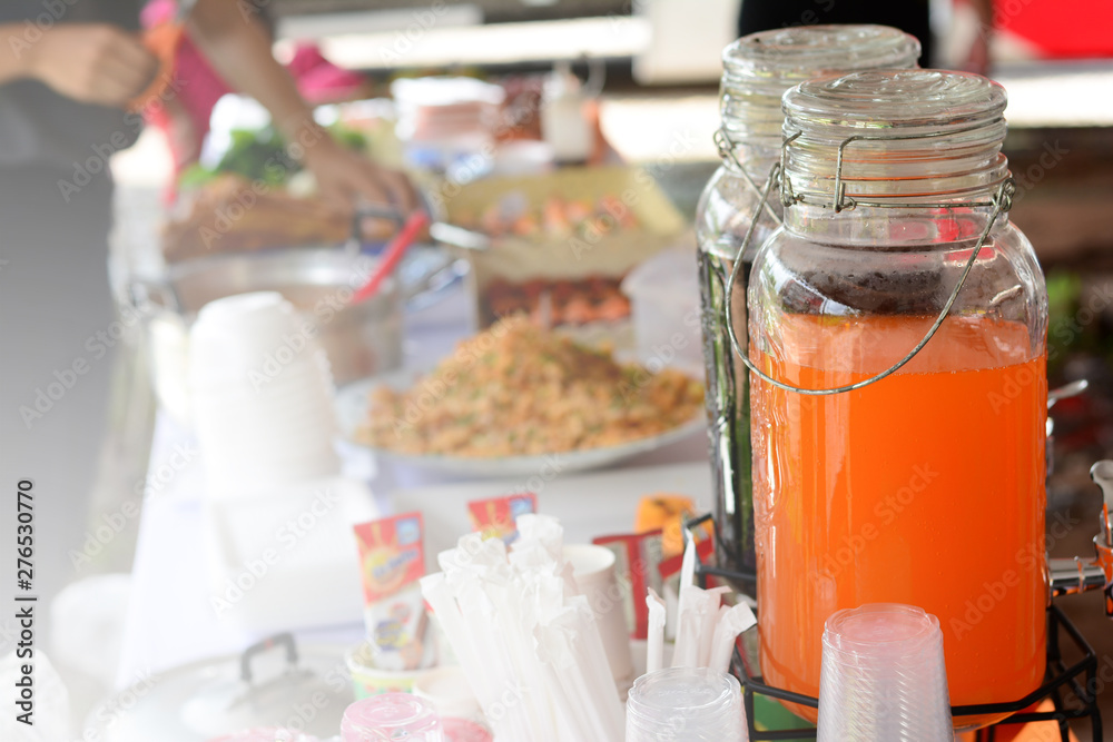 the bottle of orange and black  juices on table at  party event