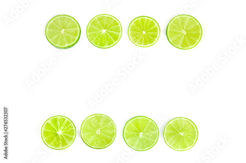 Vibrant lime slices, shot from the top on a white background, forming a frame with a place for text