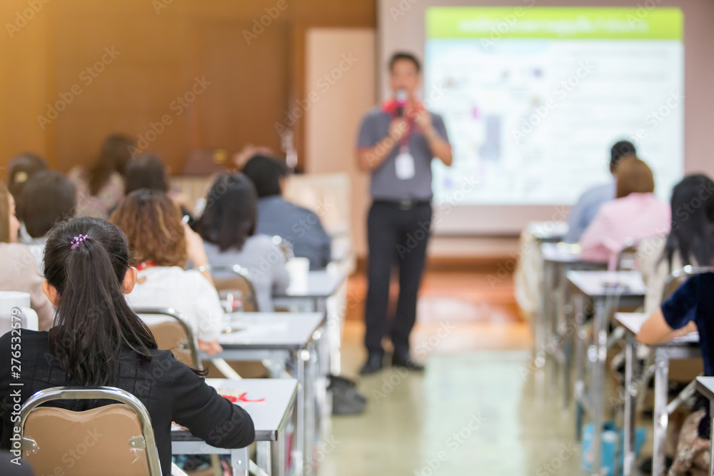 selective focus to business woman with blurry man speaker for meeting or seminar event in the meeting room. They are brain business solving problem selective focus to business woman with blurry man speaker for meeting or seminar event in the meeting room. They are brain business solving problem