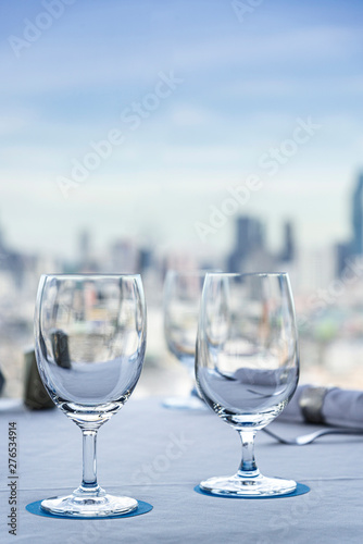 Close-up of  glass on rooftop restaurant in Bangkok cityscape blurred background., Thailand
