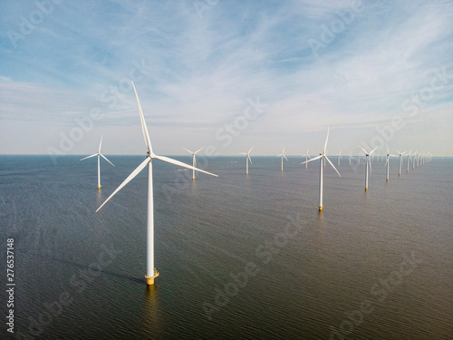 windmill farm renewable enrgy, green energy with windmill park in ocean and land photo