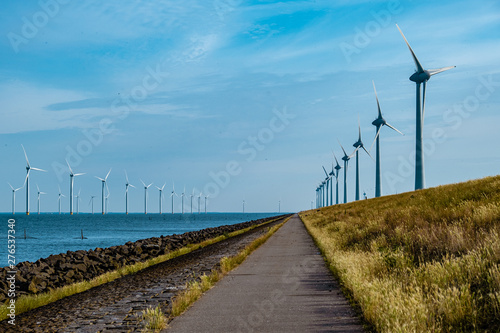 windmill farm renewable enrgy, green energy with windmill park in ocean and land photo