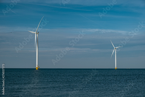 windmill farm renewable enrgy, green energy with windmill park in ocean and land photo