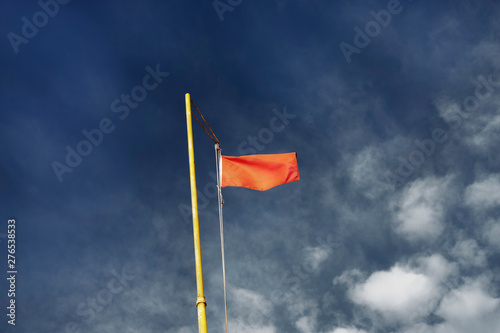 Red flag against the blue sky