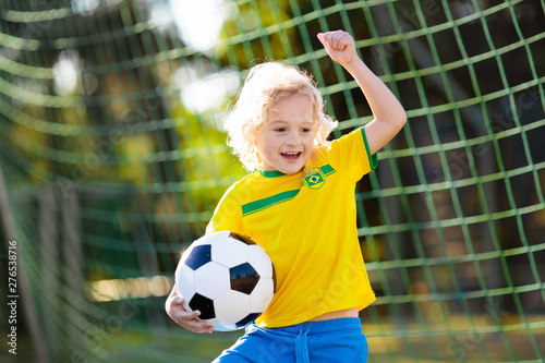 Brazil football fan kids. Children play soccer. © famveldman