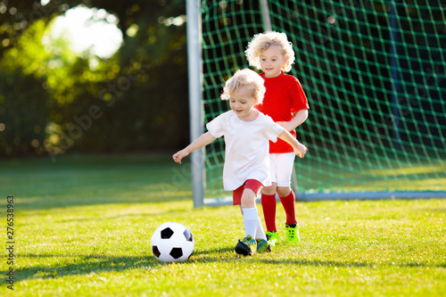 Kids play football. Child at soccer field. © famveldman