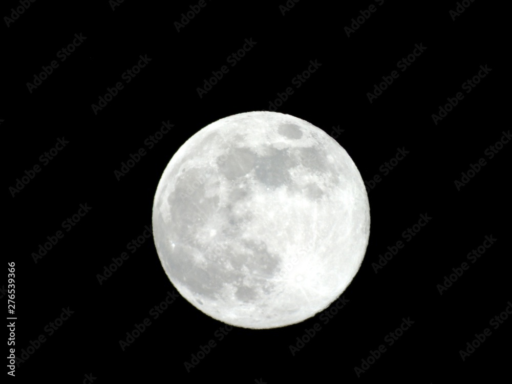 An amazing photography of the full moon over the city of Genova by night with a great clear and blue sky in the background and some stars. An amazing photography of the full moon over the city of Genova by night with a great clear and blue sky in the background and some stars.