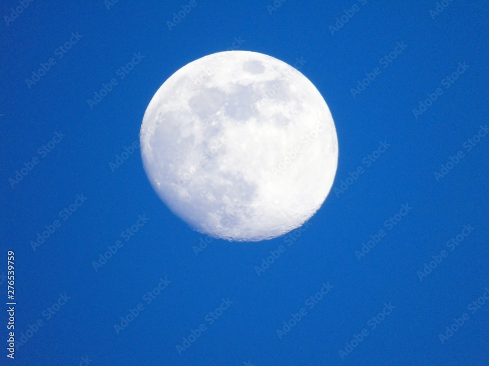 An amazing photography of the full moon over the city of Genova by night with a great clear and blue sky in the background and some stars. An amazing photography of the full moon over the city of Genova by night with a great clear and blue sky in the background and some stars.