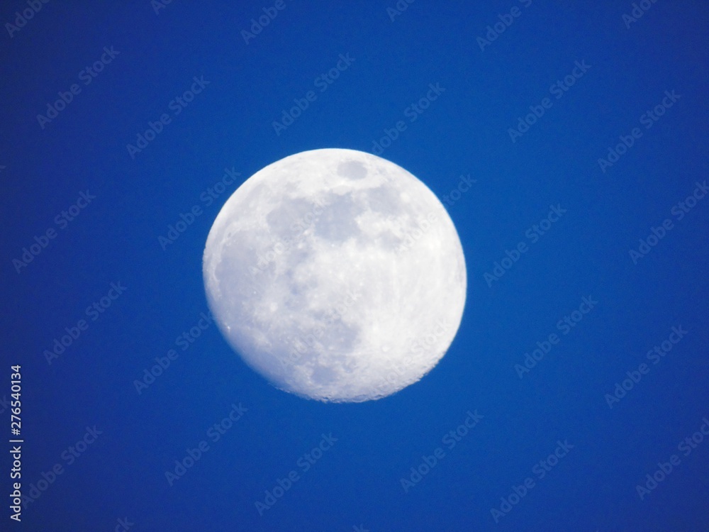 An amazing photography of the full moon over the city of Genova by night with a great clear and blue sky in the background and some stars. An amazing photography of the full moon over the city of Genova by night with a great clear and blue sky in the background and some stars.