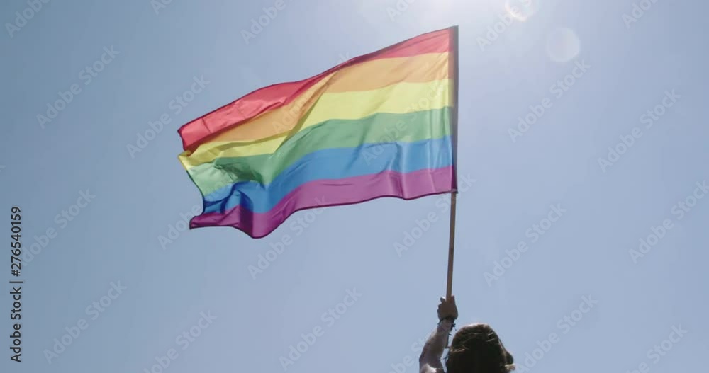 Pride LGBT rainbow flag waving in slow motion during a pride parade ...