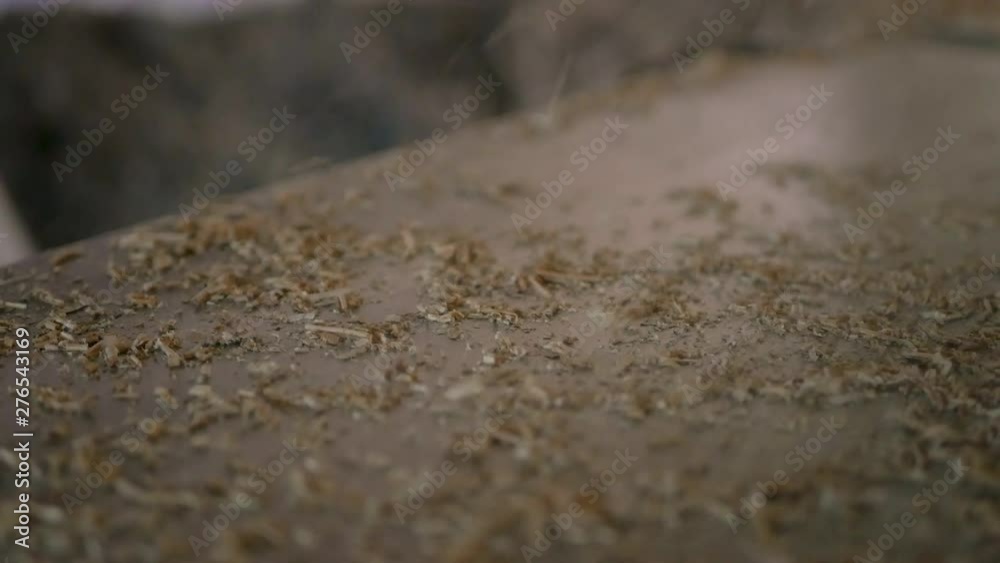 wood shavings fall on the table while carving wood wood shavings fall on the table while carving wood