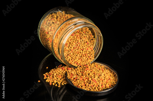 top view closeup bee pollen grain poured out from glass jar