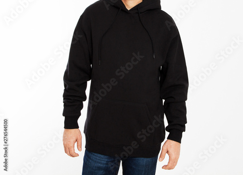 Young male hipster man wearing blank cotton sweatshirt with area for your logo, mock-up of black men hoodie, white wall in the background with copy space for your design or content