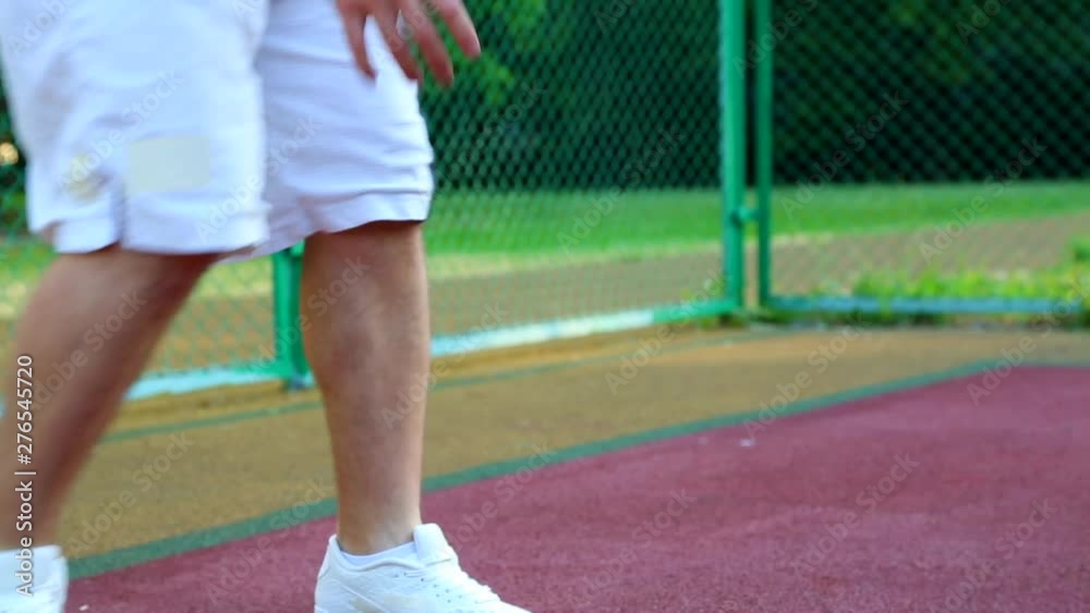 Basketball on the street, training for juggling a ball for basketball. The concept of sports, training, training on the street, self-motivation, discipline, achieving success. Close-up. Basketball on the street, training for juggling a ball for basketball. The concept of sports, training, training on the street, self-motivation, discipline, achieving success. Close-up.
