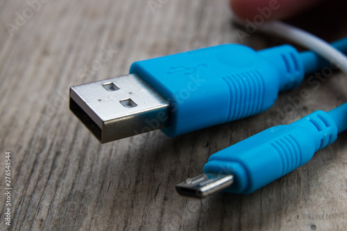 blue usb cable on a wooden board