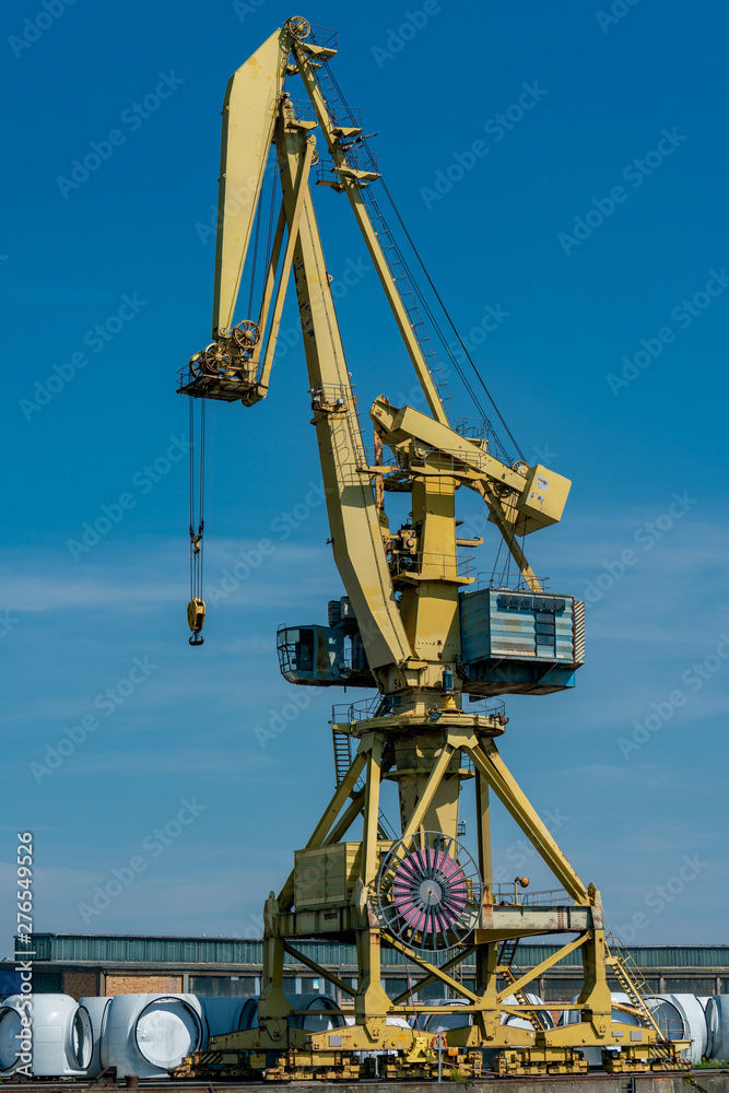 detailed yellow dockside crane at the industrial harbour in Rostock