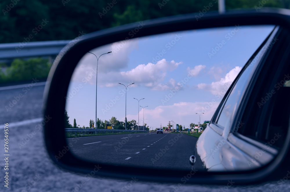 car mirror with motorway reflection