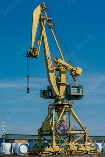 detailed yellow dockside crane at the industrial harbour in Rostock
