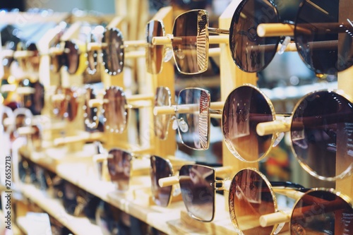 various of colorful sun glasses hang in the shop