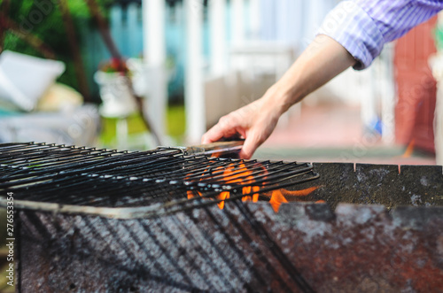 The grid of a grill gets warm on coals