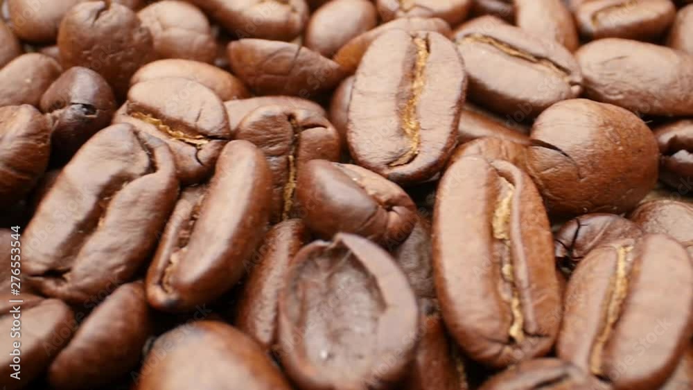 Close-up, smooth moving roasted coffee beans Close-up, smooth moving roasted coffee beans