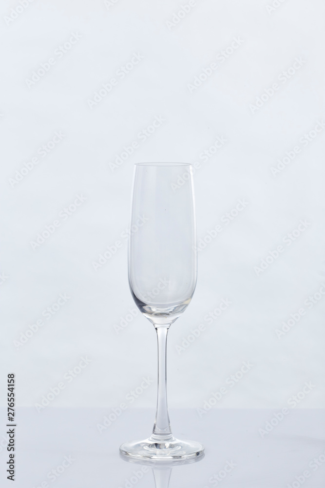 Fototapeta premium Empty Champagne Glass and Reflection on White