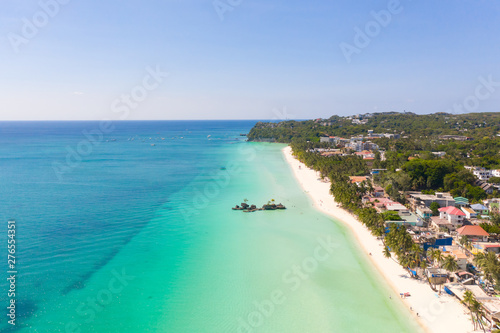 Island Boracay, Philippines, view from above. White beach with palm trees and turquoise lagoon with boats. Buildings and hotels on the big island. © Tatiana Nurieva