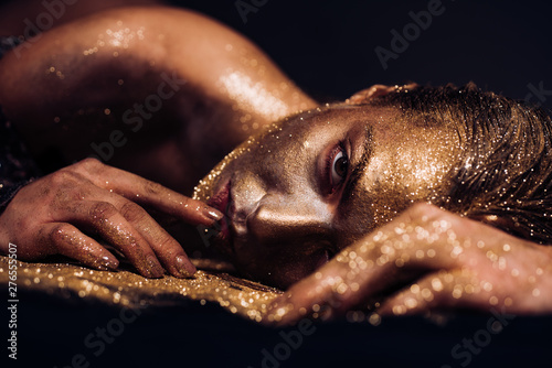 Pure gold. Vogue and glamour concept. Golden skin. Sexy girl face makeup body art metallized color. Spa wellness. Richness and wellbeing. Golden mask. Luxury beauty procedure. Golden lady relaxing photo