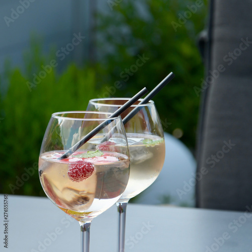 Sticker two glasses cocktail lillet pink black drinking straw with garden and table in b