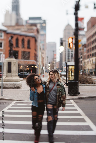 Two female friends walking in the city