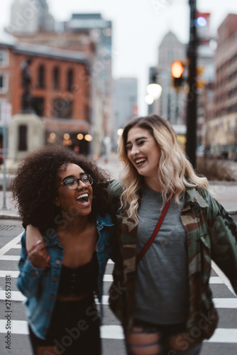 Two female friends walking in the city