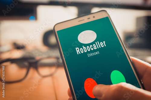Smartphone showing on screen an illegal robocall. Smartphone showing a call from a robocaller on screen photo